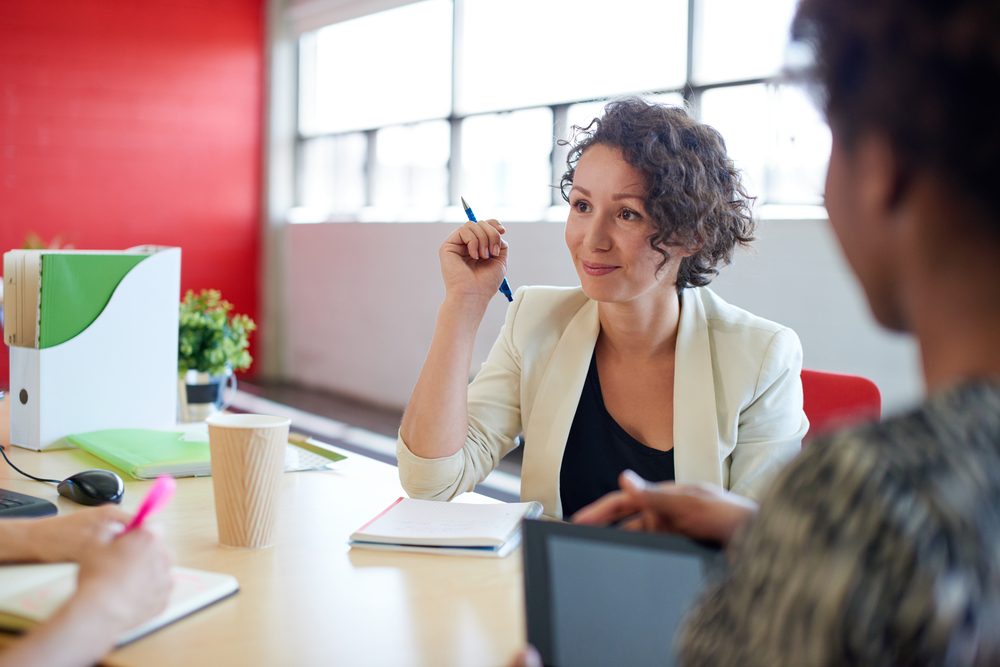 Unposed group of creative business people in an open concept office brainstorming their next project